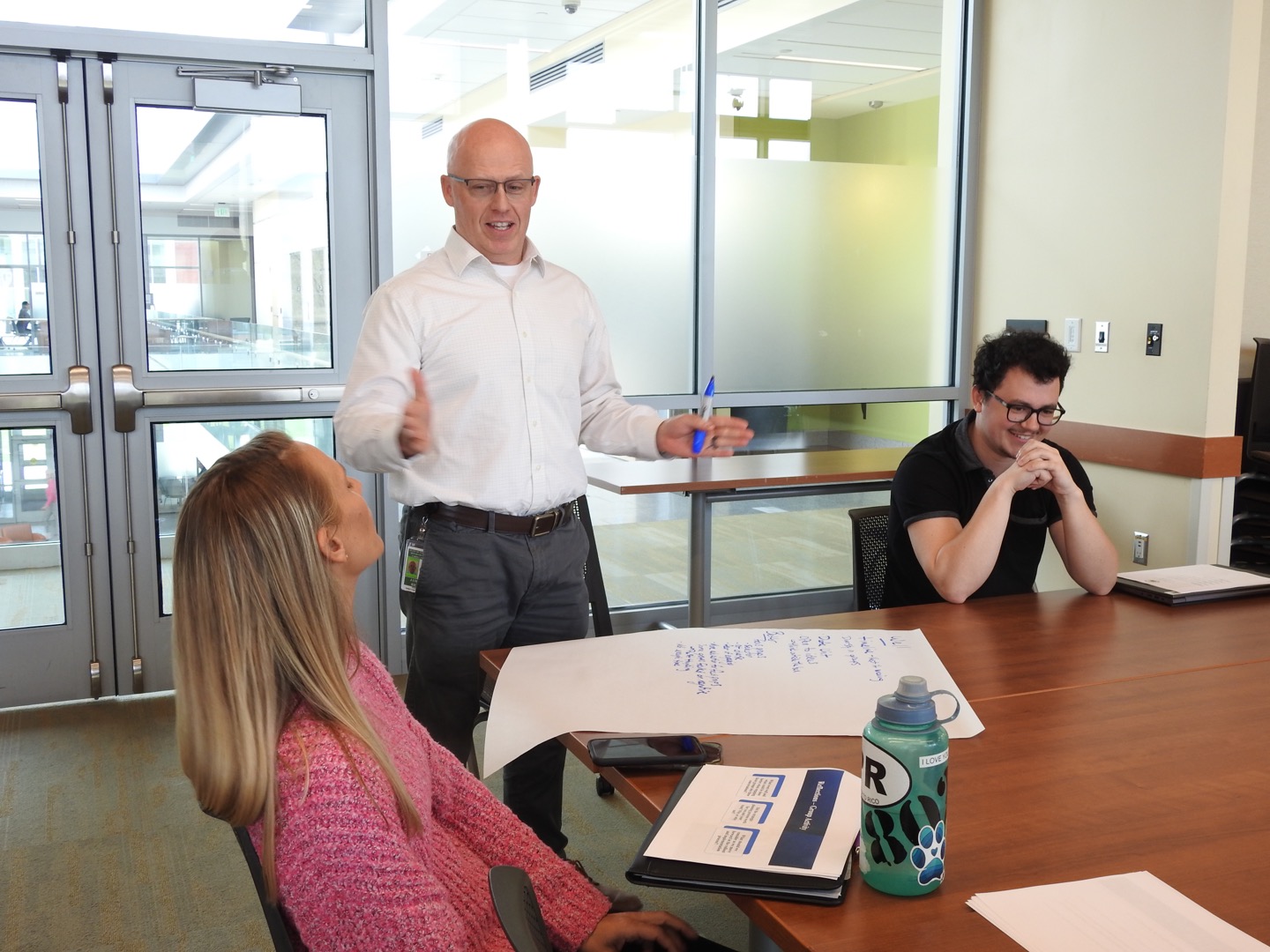 Photo of three staff members collaborating.